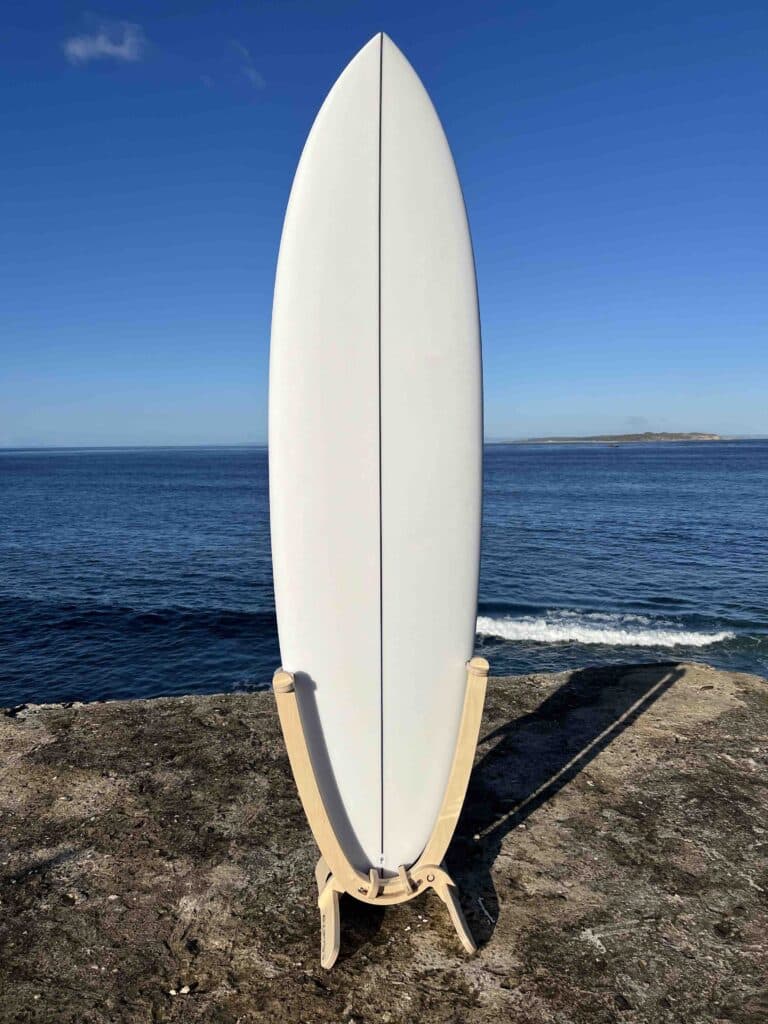 GLYD O surfboard stand with surfboard mounted, standing on Point Lonsdale lookout. Ocean and Point Nepean coastline in background.
