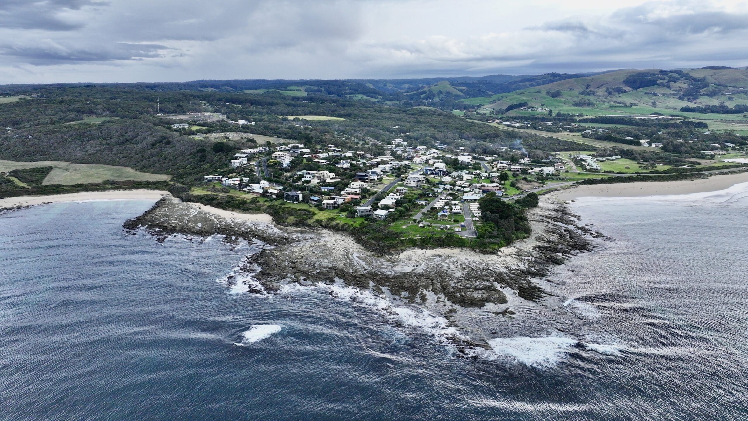 Aerial view of Marengo Point township from over ocean looking northwest showing coastal homes and Great Ocean Road community.
