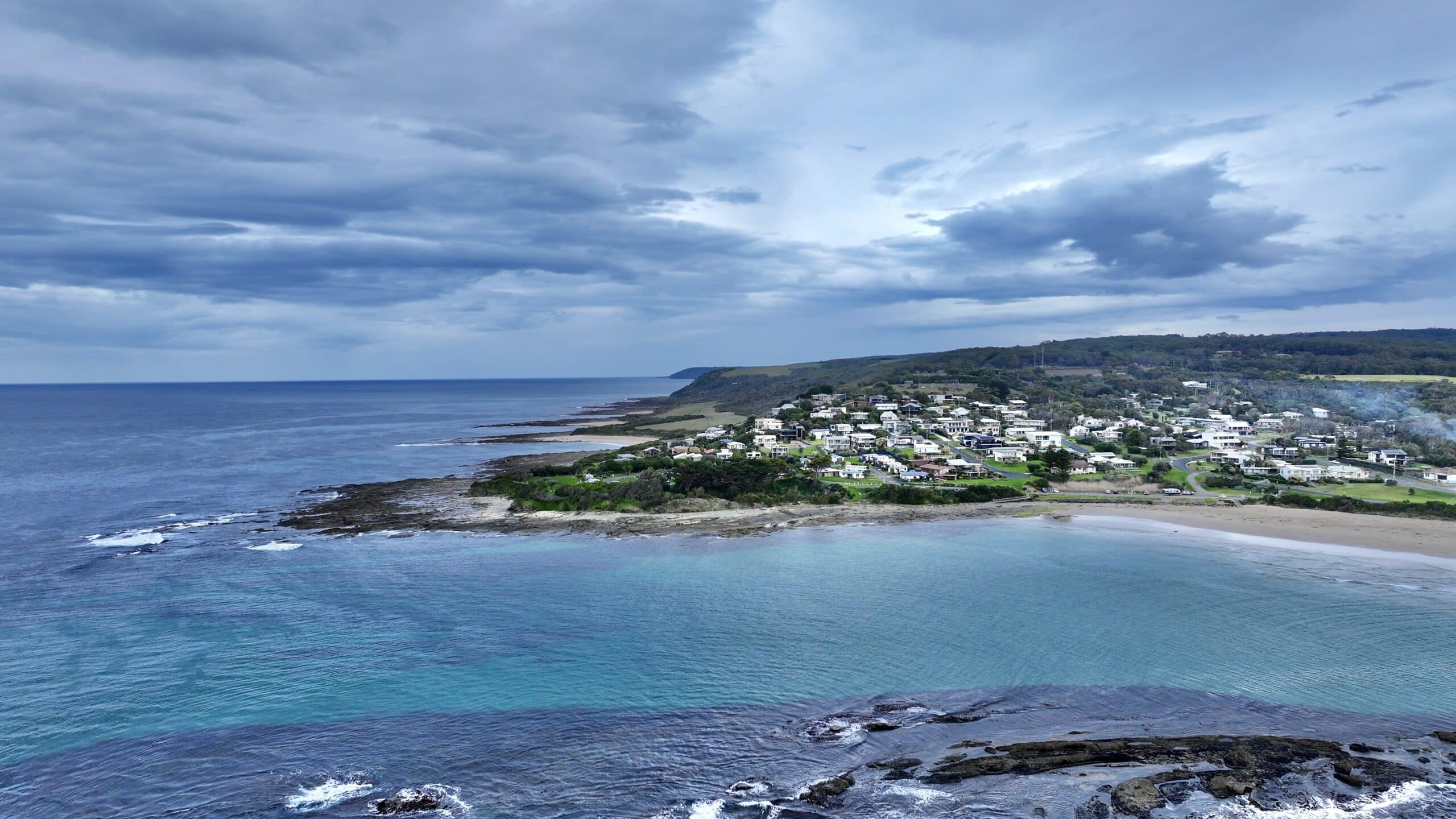 Aerial view of Marengo Point looking southwest from above reef showing turquoise waters and Great Ocean Road coastline.