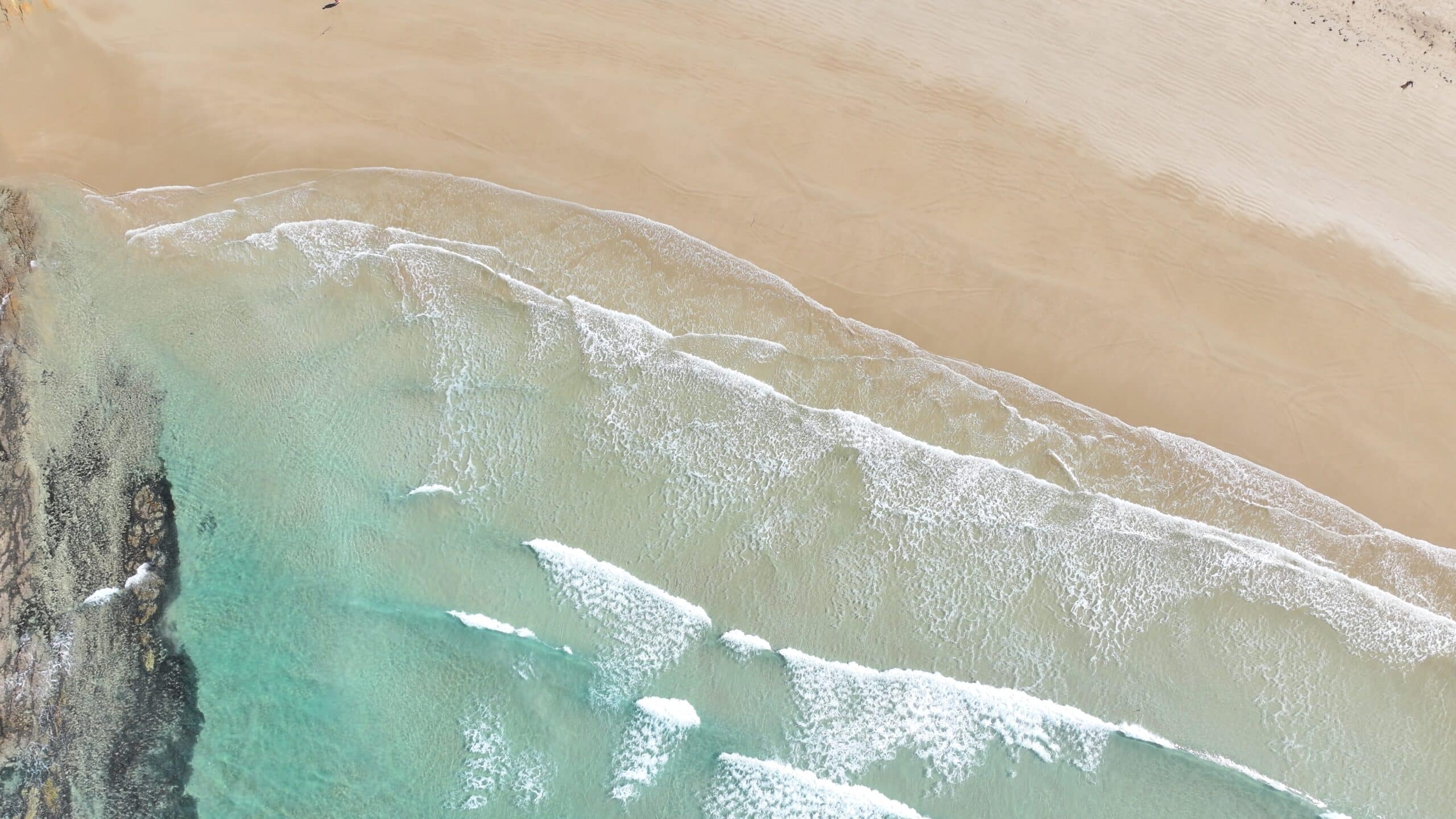 Urquharts Bluff beach aerial view waves breaking Great Ocean Road surfing destination.