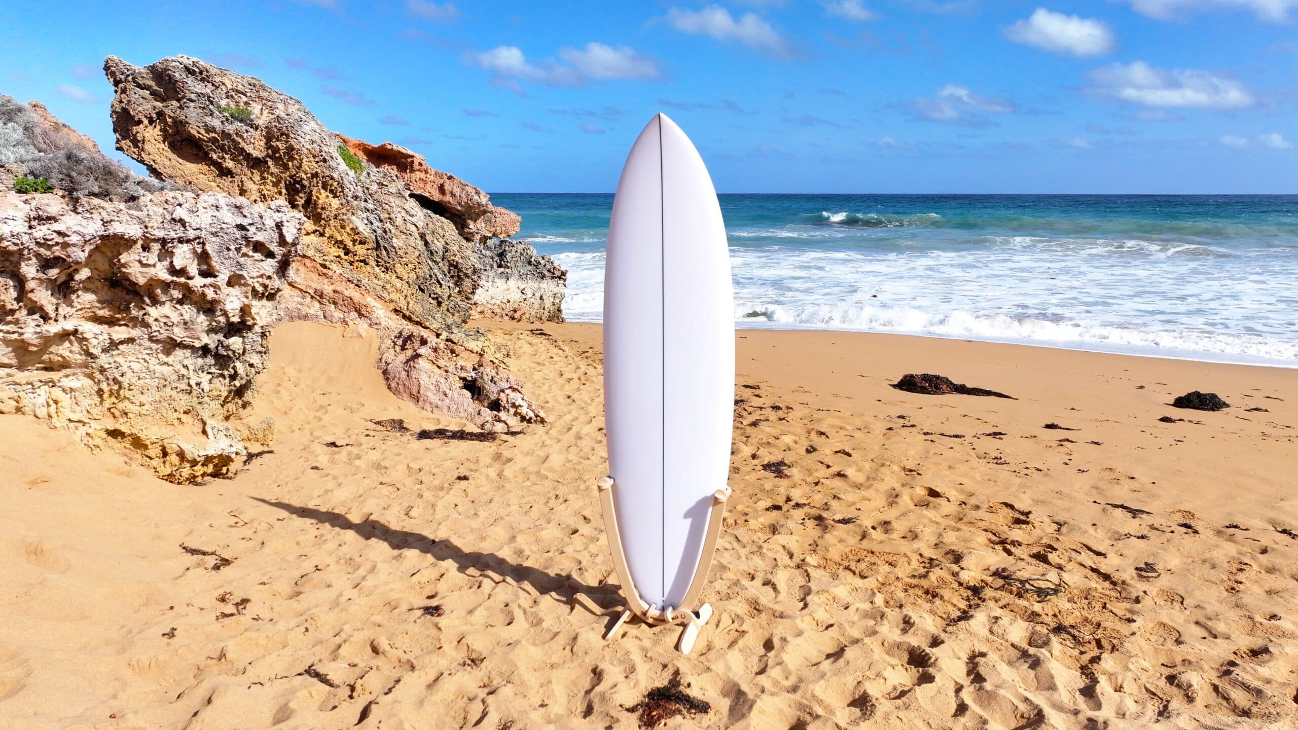 White surfboard on GLYD O 'Revolute' Freestanding Surfboard Display Stand at Point Ritchie Warrnambool beach